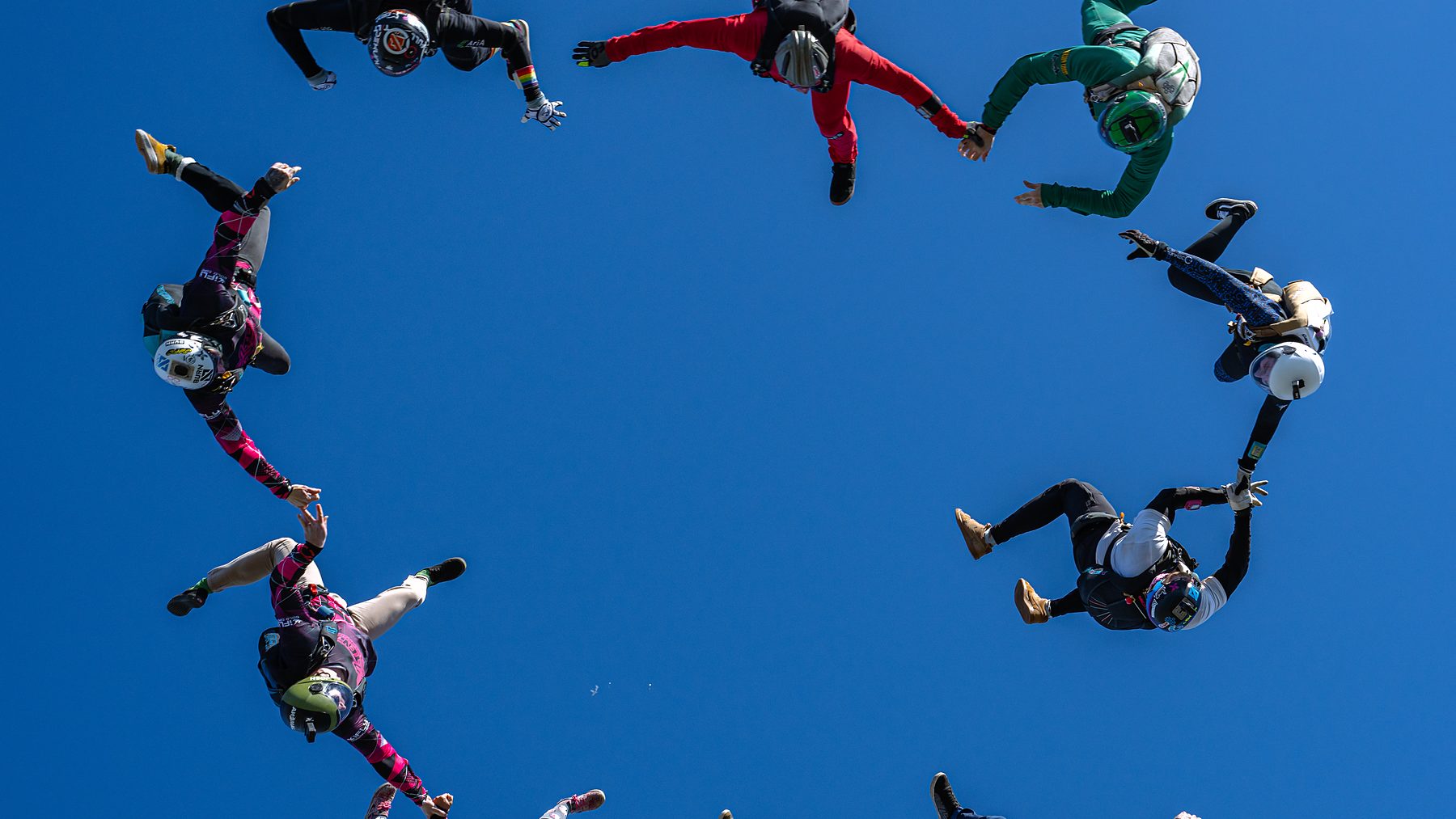 A large freefall formation gripped up against deep blue sky