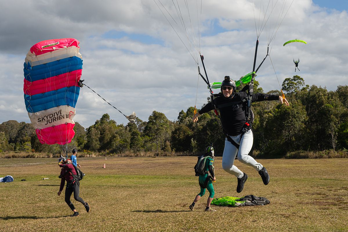 A jumper landing under a bright canopy