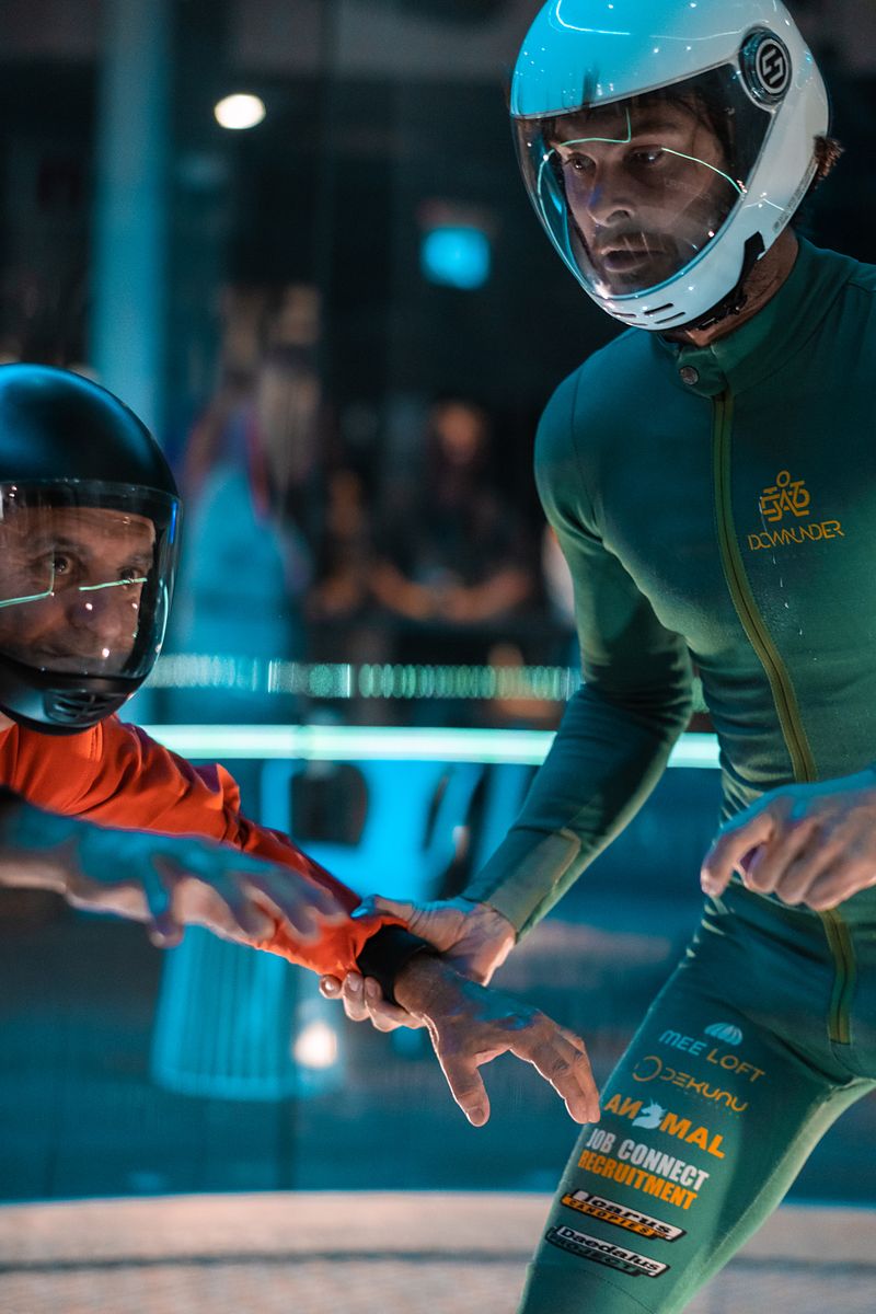 Mason guiding a flyer's arm mid-flight in the tunnel