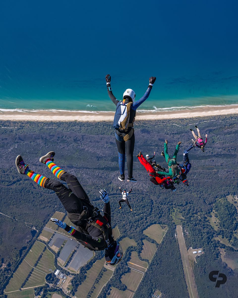 A line of flyers high above the coastline