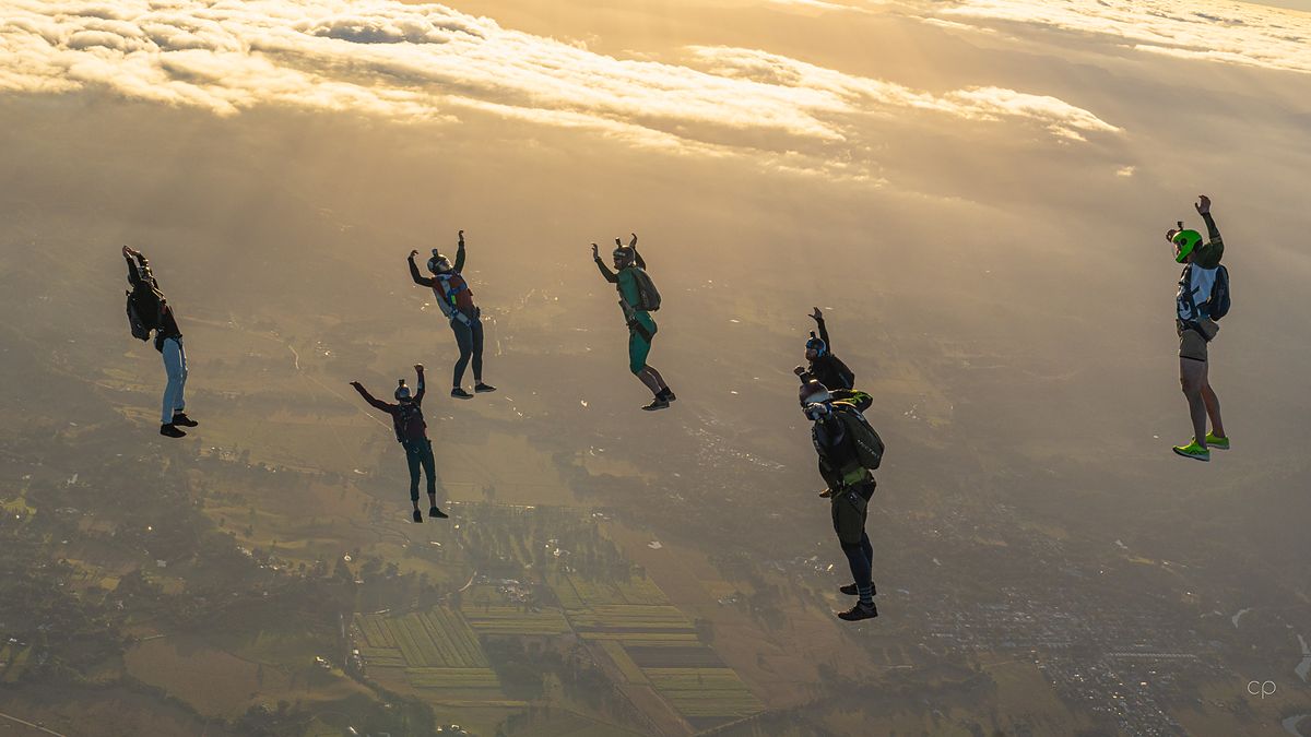 A formation in golden light above cloud