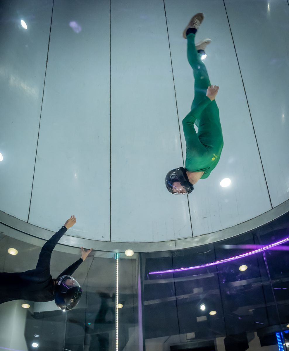 A flyer in a green suit inverted in the tunnel