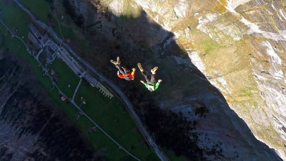 BASE jumpers flying away from the wall
