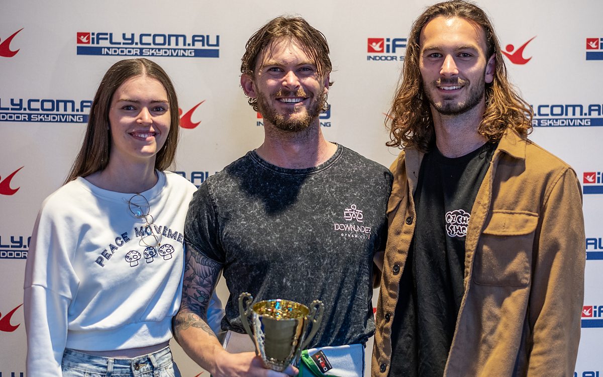 Competitors and coaches with a trophy after a tunnel competition