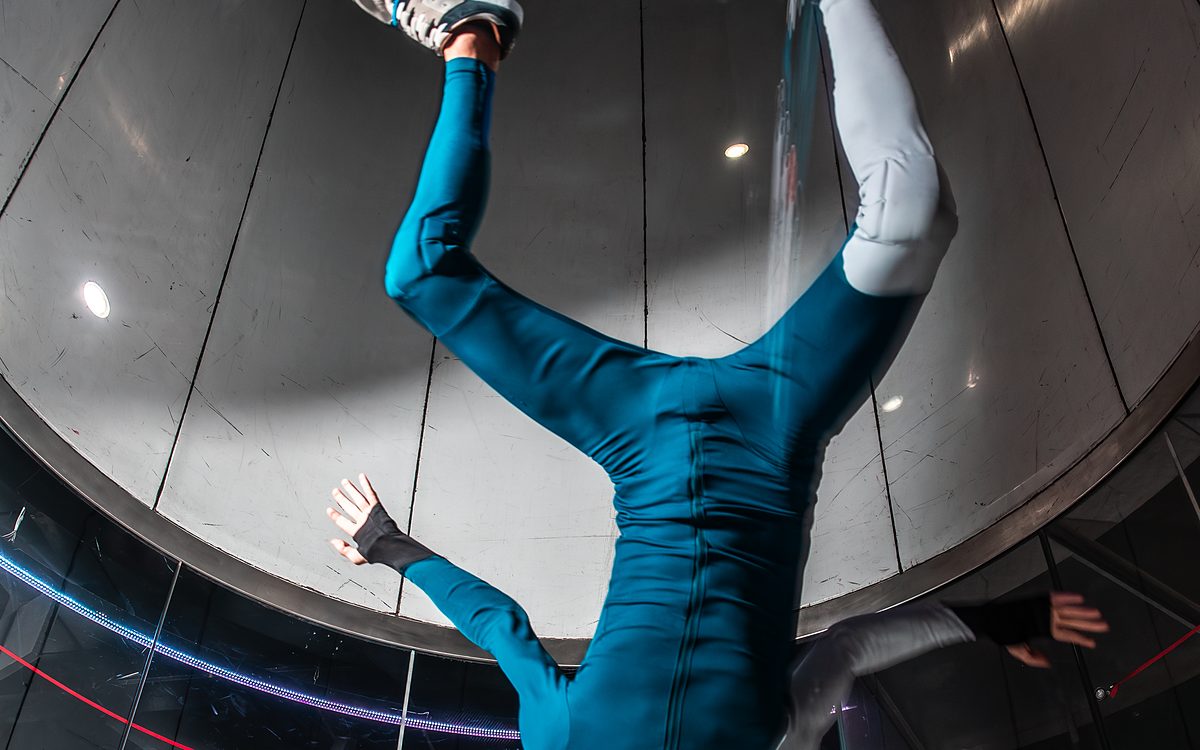 A flyer head-down in the wind tunnel during a coaching session